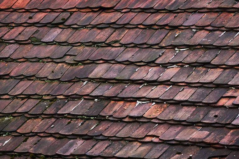 Ageing roof tiles with stains and moss growth