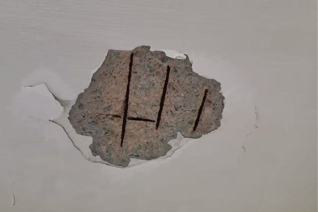 HDB ceiling spalling concrete showing flaking surface and exposed rusted rebar